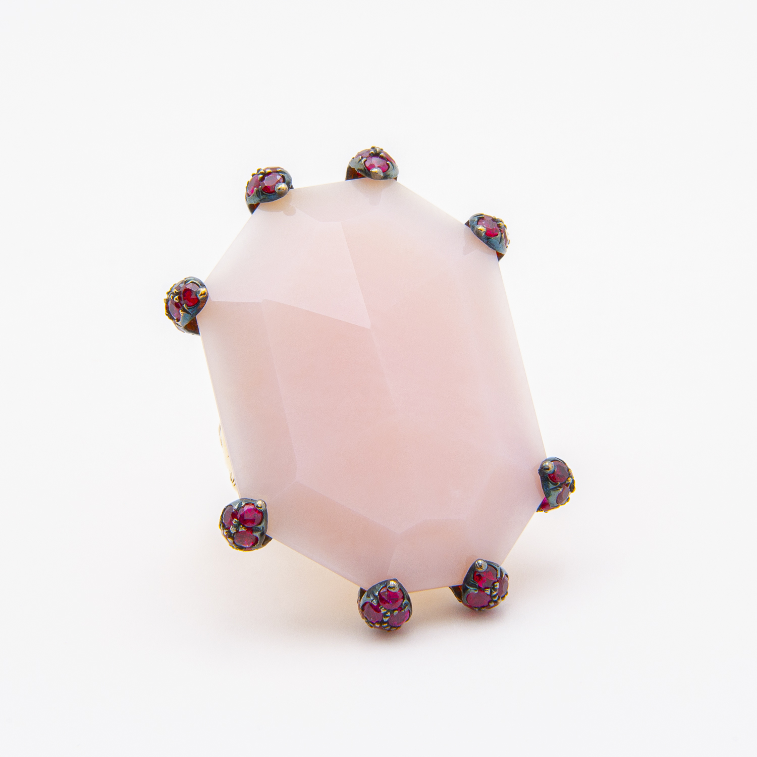 A large, faceted octagonal pink opaline gemstone is set in an 18K rose gold ring, secured by multiple decorative red and gold prongs. The background is plain white. Joieria Vintage Barcelona