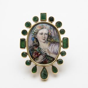 19th century brooch/pendant in 18k gold, with emeralds and fire enamel, features a painted portrait of a woman with flowers on a white background. Vintage Jewelry Barcelona